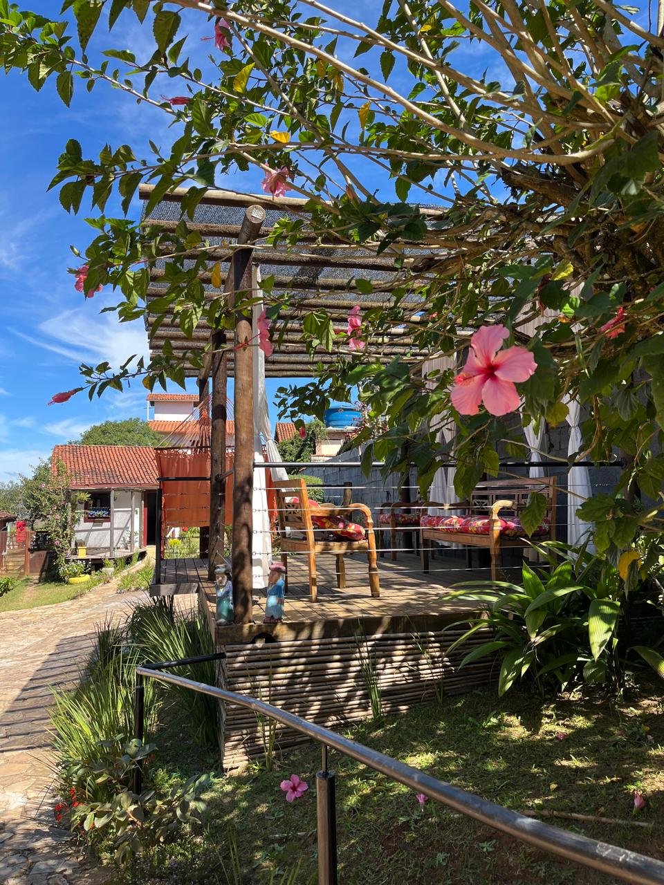 Deck com pergolado e área verde da Pousada Sesmarias